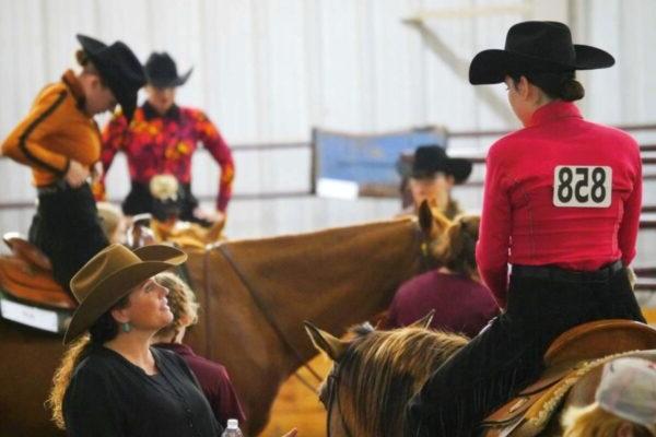 a group of people in cowchild hats riding horses